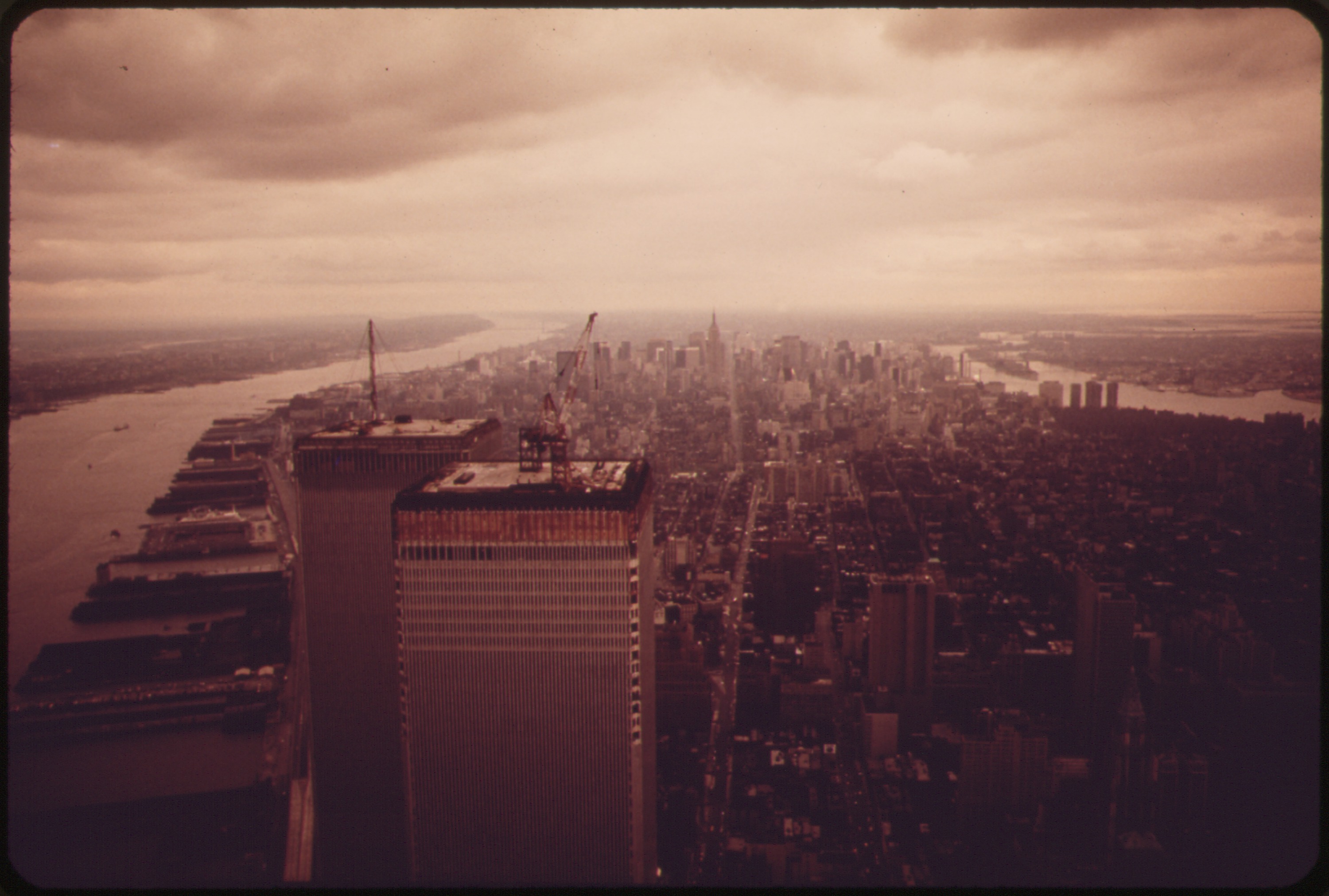 Vintage 1970s aerial photograph of Manhattan looking south, showing the World Trade Center under construction — the era when RGA Mechanical began serving New York City