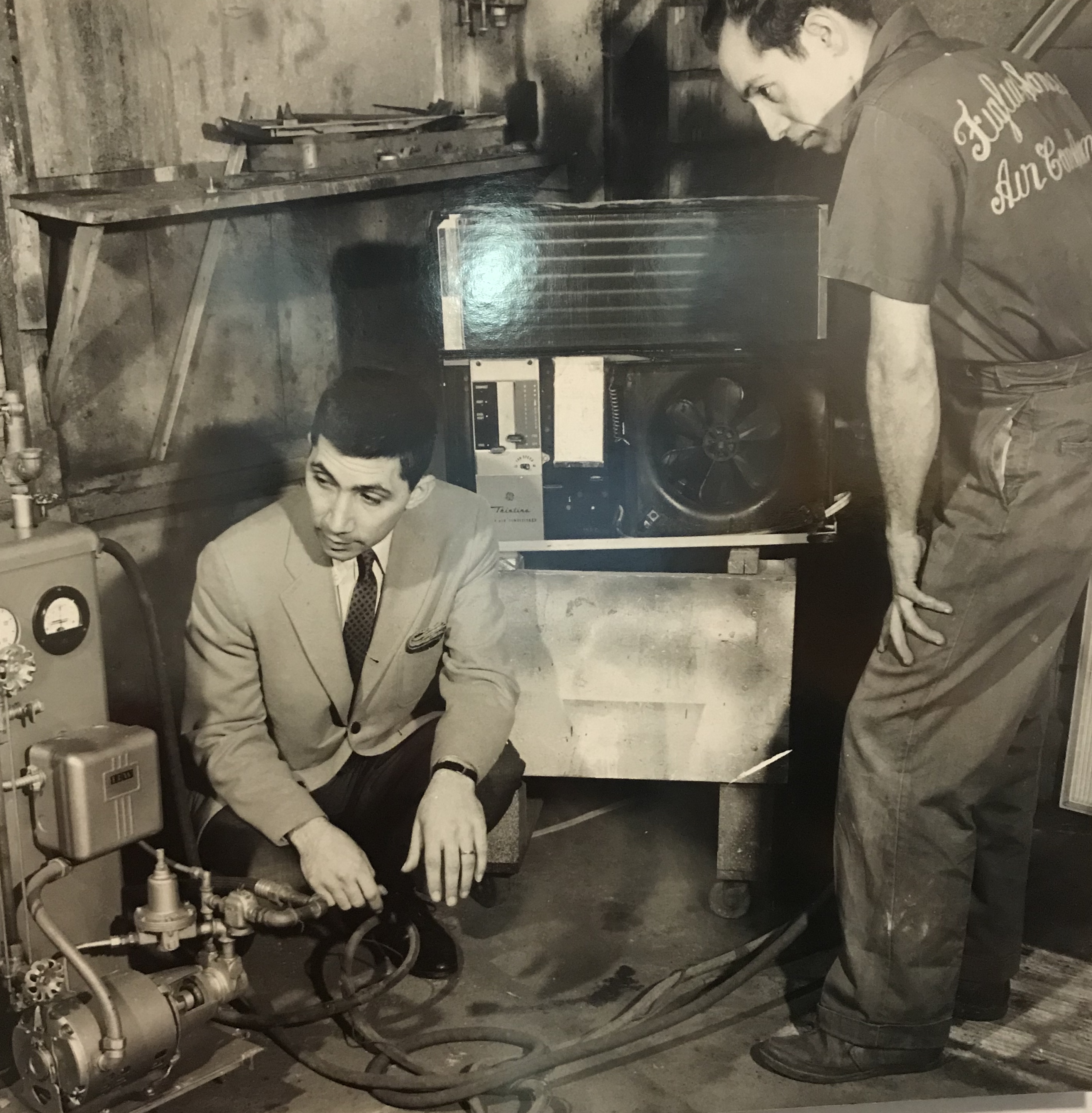Vintage photo of the Figlia family working on HVAC equipment in their shop, circa 1960